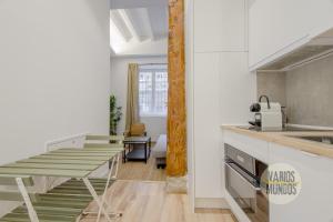 a kitchen with a table and chairs in a room at Cool And New Apt 3px entre Gran Via y Palacio Real in Madrid