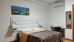 sypialnia z łóżkiem i obrazem na ścianie w obiekcie Bunker degli inventori w mieście Foggia