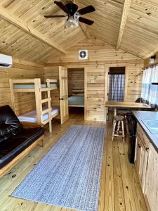 a log cabin with a ceiling fan and a bunk bed at Zion Canyon Cabins in Springdale