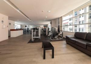 a living room with a couch and a gym at Guest Green Granada. in Mexico City