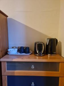 a counter with two coffee makers on top of it at Cathcart Place Rooms in Edinburgh