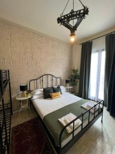 a bedroom with a large bed in front of a brick wall at Ambra Boutique Hotel in Milan