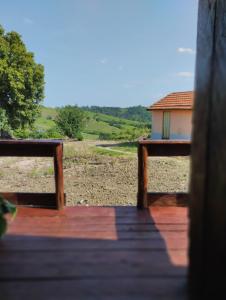 a view of a house from a wooden deck at Pousada 4 estações/chalés in Sapopema