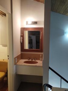 a bathroom with a sink and a mirror at Altos Penitentes Lomas Blancas, dúplex in Uspallata
