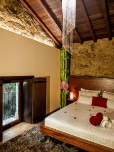 a bedroom with a bed with two hearts on it at Casa Favo de Mel - Jacuzzi Privado in Arcos de Valdevez