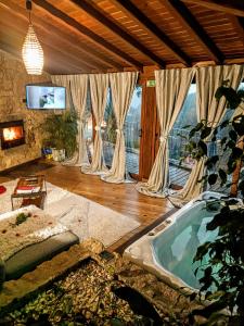 a living room with a jacuzzi tub in a room at Casa Favo de Mel - Jacuzzi Privado in Arcos de Valdevez