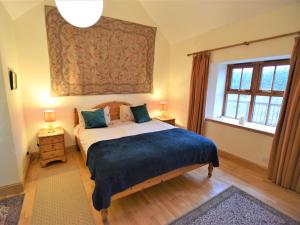 a bedroom with a large bed and a window at 2 bed property in Cairnbaan CA113 in Cairnbaan