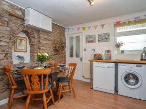 a kitchen and dining room with a table and chairs at 2 bed in Brixham 77769 in Brixham