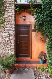 a door to a house with two potted plants at Apartamentos Rurales San Pedro in Valencia de Alcántara