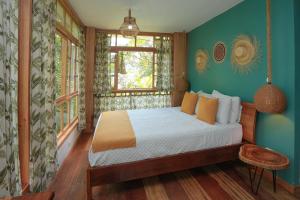 a bedroom with a bed in a room at Casa de Vista Alta in Mindo