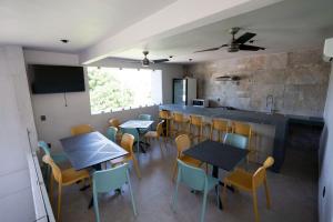 a restaurant with tables and chairs and a counter at Sophie Hotel Boutique in Santa Cruz Huatulco