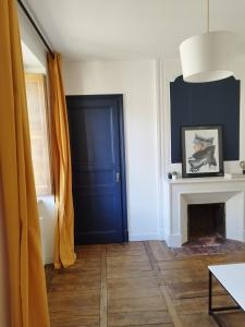 a room with a blue door and a fireplace at ROMANESCO in Rennes