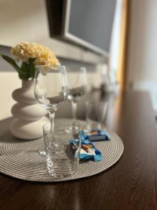 a table with two wine glasses and a plate on it at AR GOLDEN HOUSE in Košice