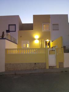 a yellow house with a fence and a gate at Casa Yucca in Salema