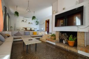 a living room with a couch and a fireplace at Casa del Abuelo Isla Canela in Isla Canela