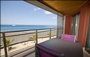 a balcony with a table and a view of the beach at LAS MAREAS in Tazacorte