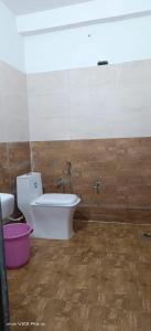 a bathroom with a toilet and a bidet at haridwar jmg and kedarnath Hotel in Haridwār