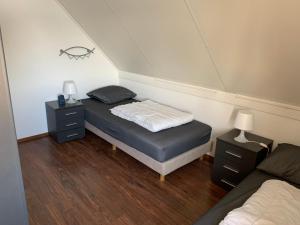 a room with two beds and two night stands at Kustverhuur, Park Scheldeveste Zwin 065 in Breskens +21 photos