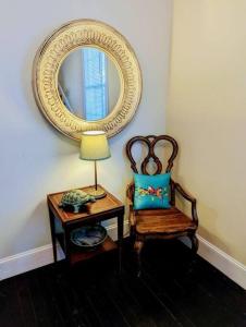 a room with a lamp and a chair and a mirror at Dunes Suite (Work Friendly) in Florence