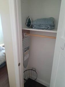 a room with a closet with a shelf and a pillow at Dunes Suite (Work Friendly) in Florence