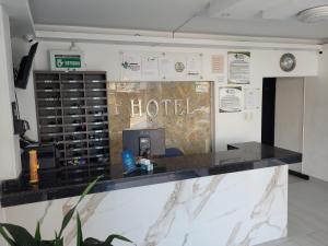 a hotel counter in a room with a sign that reads hotel at Hotel Palmeras De Mariana in Bucaramanga