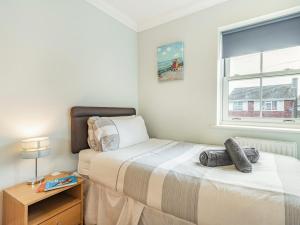 a bedroom with two beds and a window at 3 Bed in Christchurch 73946 in Christchurch