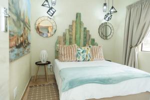 a bedroom with a bed with a cactus headboard at Pumbaa Wildlife Park & Accommodation in Nelspruit