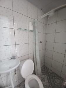 a white bathroom with a toilet and a sink at Hostel Sol da Barra in Salvador +39 photos