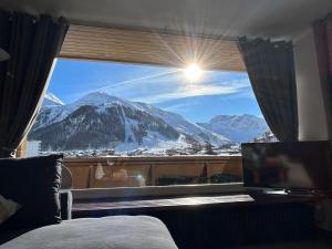 a room with a window with a view of a mountain at Le Portillo in Val-d'Isère