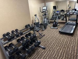 a fitness room with treadmills and cardio machines at Super 8 by Wyndham Alexandria LA in Alexandria