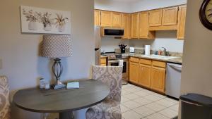 a small kitchen with a table and a dining room at Peaceful Flagstaff Condo in Flagstaff