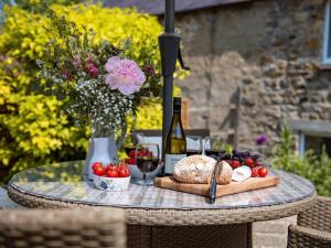 a table with a bottle of wine and bread and flowers at 2 Bed in Richmond G0059 in Richmond