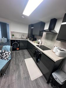a kitchen with a sink and a counter top at Stunning 2-flat in Leicester! in Leicester