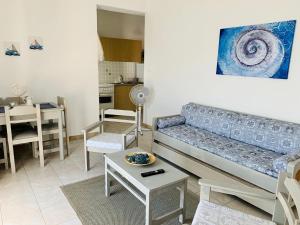 a living room with a couch and a table at Aegean Aura Apartment II in Kalymnos