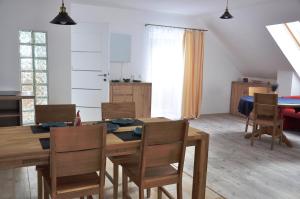 a kitchen and dining room with a table and chairs at DOM WITA I MAŁGOSI in Podgórzyn