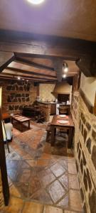 a kitchen with a table and a stone wall at Cueva árabe en el casco antiguo, Toledo in Toledo