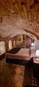 a bedroom with a large bed in a stone room at Cueva árabe en el casco antiguo, Toledo in Toledo