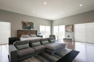 a living room with a couch and a bed at Architectural Gem La Jolla Oceanview Surf And Golf in San Diego