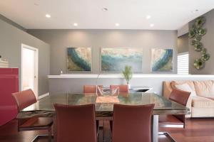 a dining room with a glass table and chairs at Architectural Gem La Jolla Oceanview Surf And Golf in San Diego