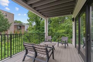 a screened porch with two chairs and a table at Winton Flats by MilaPad in Atlanta