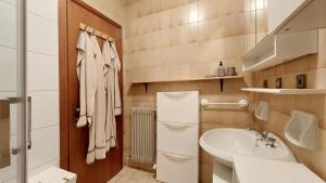 a small bathroom with a sink and a toilet at Mountain Apartment Rododendro in Tarvisio