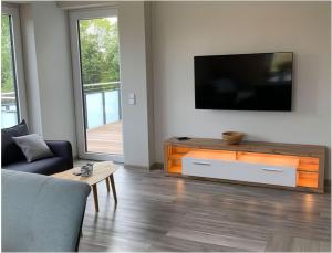 a living room with a flat screen tv and a couch at Ferienwohnung - James Cook in Petersdorf auf Fehmarn