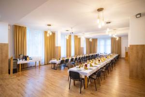 a large banquet hall with tables and chairs at Magnificat in Niechobrz