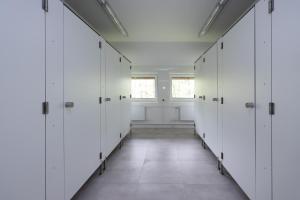 a row of white lockers in a hallway at Magnificat in Niechobrz