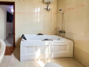 a bath tub in a bathroom with a shower at Fey Pad in Lagos