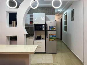 a kitchen with a refrigerator in a room at Fey Pad in Lagos