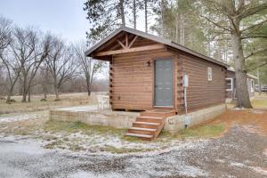 a small wooden cabin with a door and stairs at Mauston Studio Cabin about 15 Mi to Wisconsin Dells! in Lyndon Station