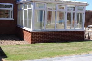 a conservatory on the side of a house at Remarkable 2-Bed House in Walesby Nottinghamshire in Elkesley