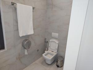 a bathroom with a toilet and a towel on the wall at ViLa Bakri in Elbasan