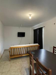 a room with a stage and a table and a television at DUPLEX BV in Bell Ville